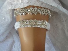 Sparkle Wedding Garter Set, Crystal Bridal Garter, Rhinestone Keepsake Garter, Glam Wedding Garter, Bling Bridal Garter, Garder MY NEWEST RHINESTONE GLAM GARTER SET!! Available in White, Ivory or Aqua in drop down menu. Other colors available by request. Can be purchased as single keepsake garter or garter set with toss in drop down menu. Clear round, marquise shaped rhinestone surrounded by tiny round rhinestone and accented with   baguettes and medium round rhinestones compliment each other in a very regal rhinestone trim.  The stones are Czech stones of brilliant quality. The light dances through them creating incredible sparkle and shine. This set is nothing short of brilliant.  Rhinestone trim is 1 inch wide.   The toss garter uses a smaller piece of rhinestone trim set on a gathered Crystal Garter, Rhinestone Garter, Blue Garter, Wedding Garter Set, Mint Wedding, Sparkle Wedding, Glitter Wedding, Bridal Garter, Wedding Garter