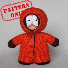 a crocheted stuffed animal wearing an orange jacket