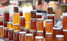 many jars filled with liquid sitting on top of a table