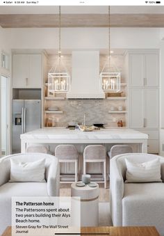 a kitchen and living room with white furniture