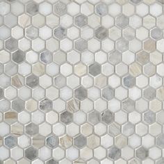 a white and grey mosaic tile pattern with hexagonal tiles on the bottom half