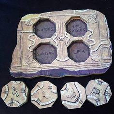 an old stone tray with four different designs on it and five smaller ones next to it