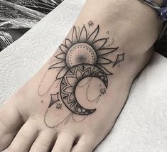 a sun and moon tattoo on the foot