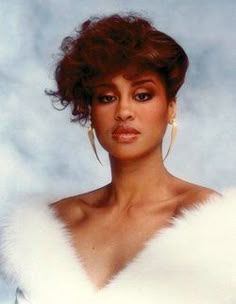 an old photo of a woman with curly hair