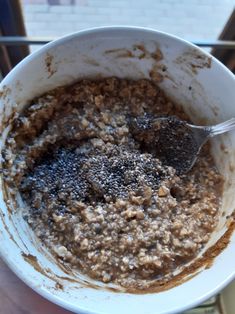 a white bowl filled with oatmeal sitting on top of a table