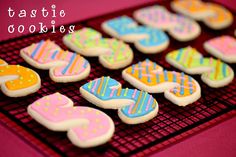 decorated cookies on a cooling rack with the words pastel cookies written in large letters