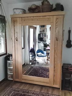 a large wooden cabinet sitting in the middle of a living room