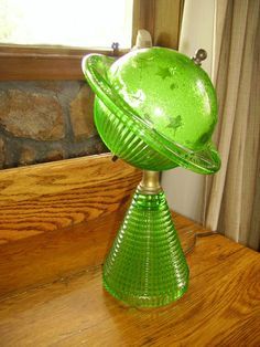 a green glass dish sitting on top of a wooden table