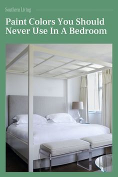 a white bed sitting in a bedroom next to a window