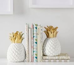 two pineapple shaped booksends sitting next to each other on top of a table