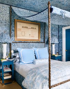 a bedroom with blue and white decor on the walls