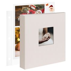 a white photo album with christmas pictures on it