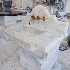 a white marble sink sitting on top of a counter