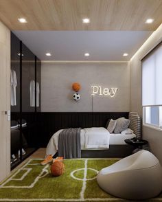 a bedroom with a soccer theme on the wall and a green rug in front of it