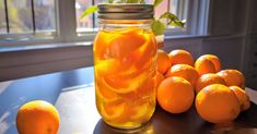 a jar filled with oranges sitting on top of a table