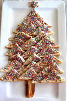 a christmas tree made out of crackers on a plate