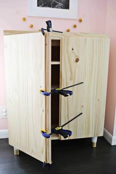 a wooden cabinet with skis on the bottom and two ski poles sticking out of it