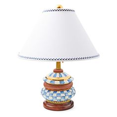 a blue and white checkered lamp on a wooden base with a white lampshade