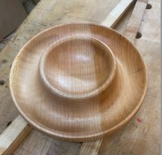 a wooden bowl sitting on top of a table