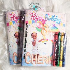 two children's birthday books with crayons in them