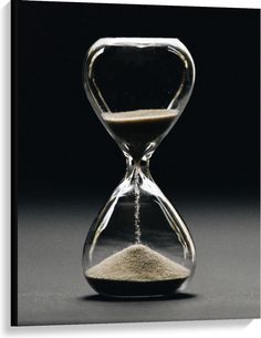 an hourglass with sand in it sitting on a table