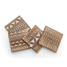 four wooden coasters with geometric designs on the top and one has a white background