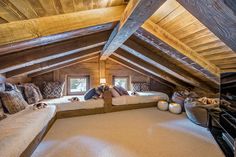 there are two beds in the attic with pillows on them