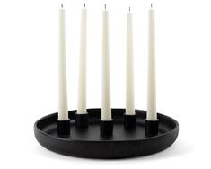 six candles are placed in a black holder with four white ones on it's sides