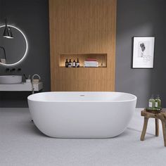 a white bath tub sitting in a bathroom next to a wooden table and stools