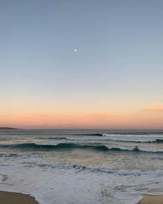 the sun is setting over the ocean waves