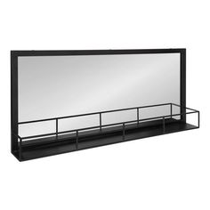 a large mirror sitting on top of a shelf