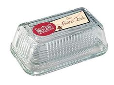 an empty glass butter dish with a label on it