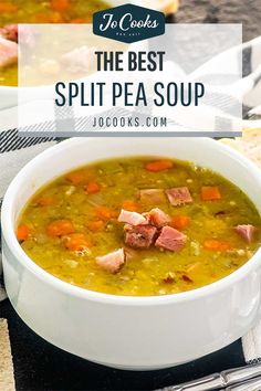 two bowls of split pea soup with ham and carrots in the middle, on a table