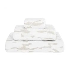 two white towels on top of each other in front of a white background with fish