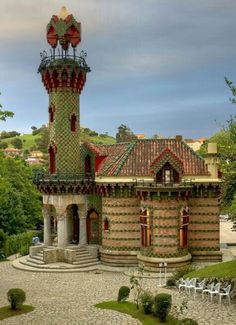 an old building with a clock tower in the middle of it's garden area