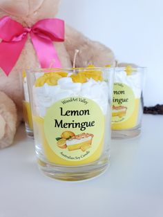 two glasses with lemon meringue on them next to a teddy bear