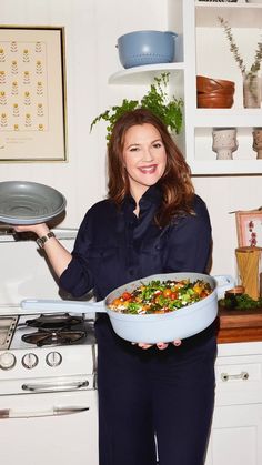 a woman is holding a dish in her hands