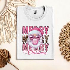 Leopard Merry Christmas Sweatshirt, Pink Christmas Sweatshirt, Girly Christmas T-Shirt, Cute Pink Santa Tee, Xmas Gift For Family The Standard T-Shirt, personalized to suit your individual style, serves as the perfect medium for self-expression. Made from 100% preshrunk cotton, this timeless short-sleeve tee not only ensures comfort but also offers ample opportunities for print-on-demand customization. Whether you seek to showcase your creativity, promote your brand, or commemorate a special occ Pink Graphic Print T-shirt For Winter, Pink Graphic Print Christmas Tops, Christmas Pink T-shirt With Letter Print, Pink Short Sleeve Holiday T-shirt, Pink Christmas T-shirt With Short Sleeves, Santa Tee, Girly Christmas, Pink Santa, Christmas T Shirt