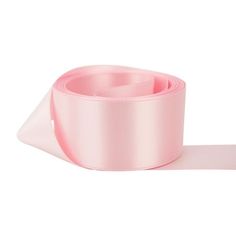 a roll of pink satin ribbon on a white background