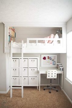 a white loft bed sitting next to a desk with drawers and a computer on top of it