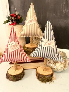 three christmas trees made out of wood are sitting on a table