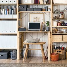 a room filled with lots of wooden shelves