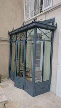 the corner of a building with an open door and glass doors on it's side