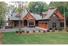 a large stone and wood house in the woods