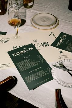 a table topped with wine glasses and menus