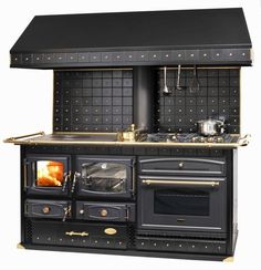 an old fashioned black stove with two ovens