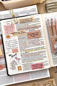 an open bible with markers and pens on it next to other items that include crayons