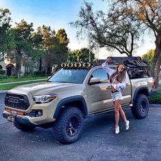 a woman standing in front of a truck