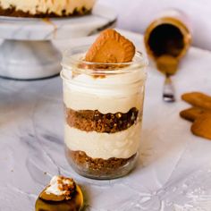 there is a dessert in a glass jar on the table next to other desserts