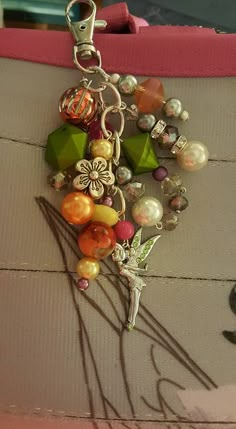 a close up of a key chain with beads and other items on top of it